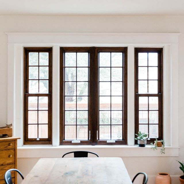 a dining table with chairs and a window